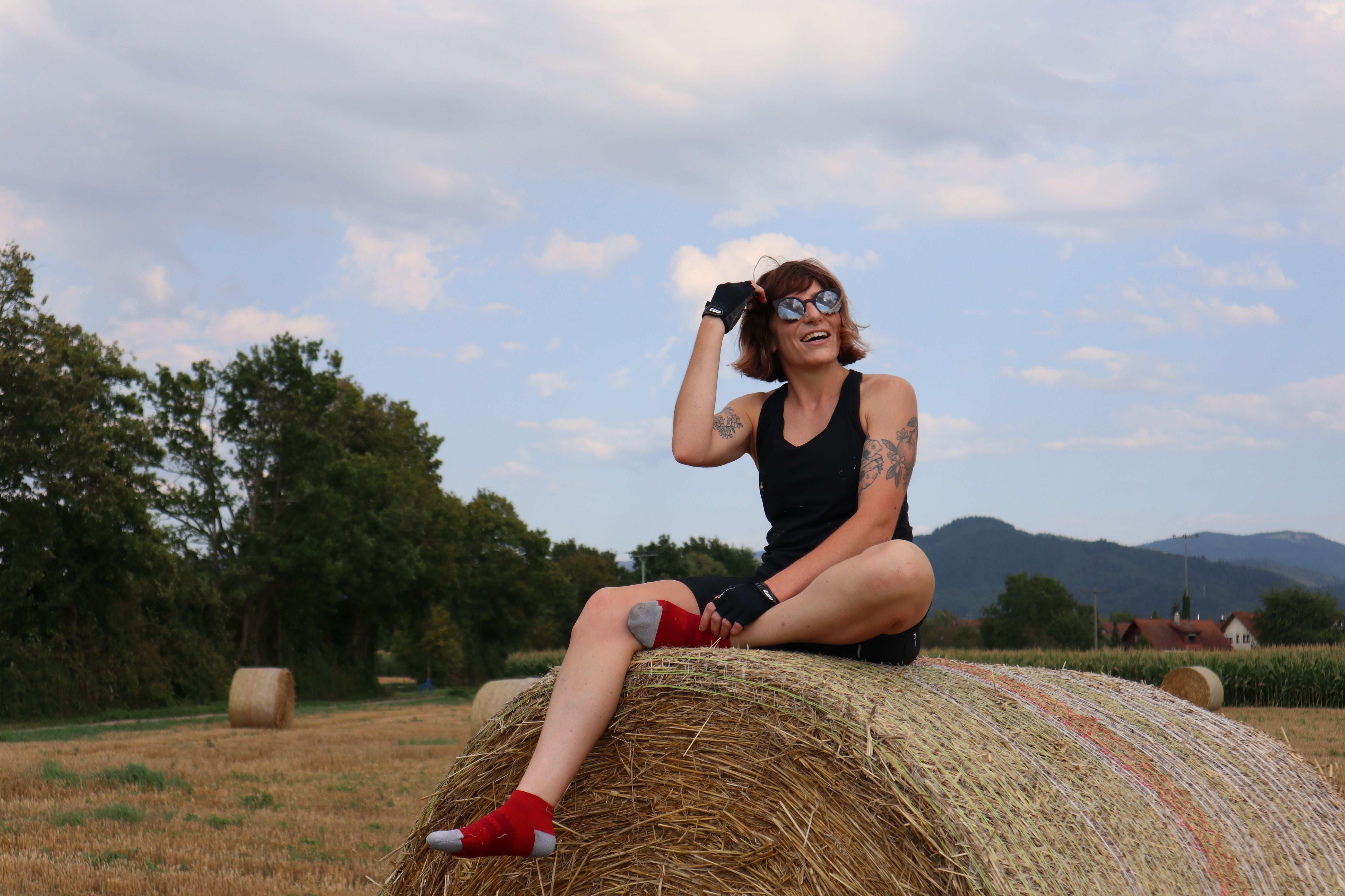Rosalie sitting on a hay bale
